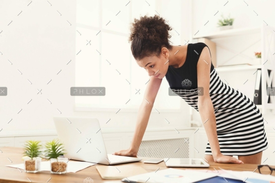 demo-attachment-115-business-woman-working-on-laptop-at-office-PRFJKQJ